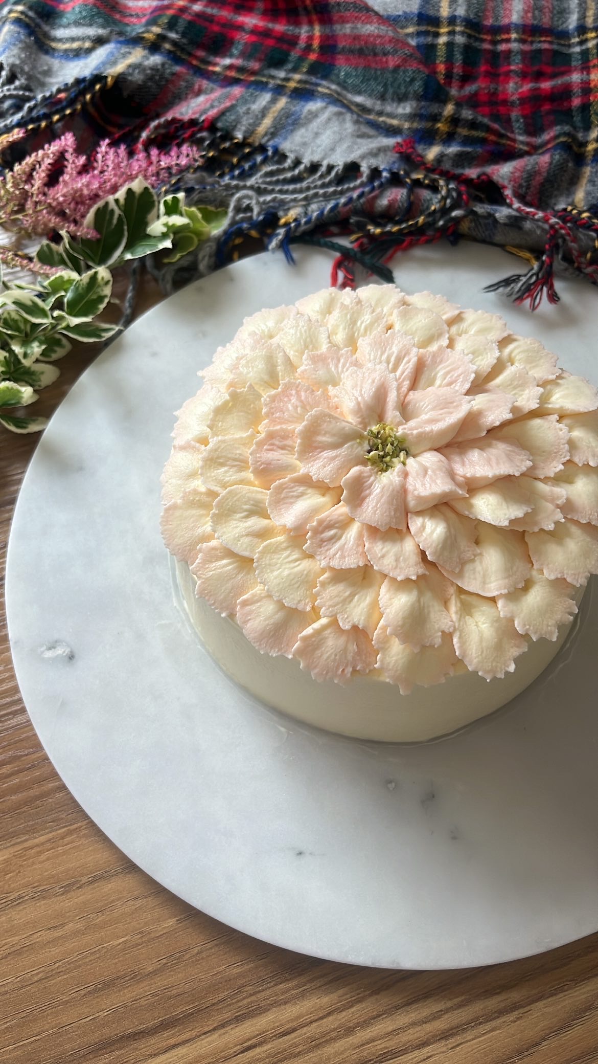 Cake decorated with cream piped in flower shape on top